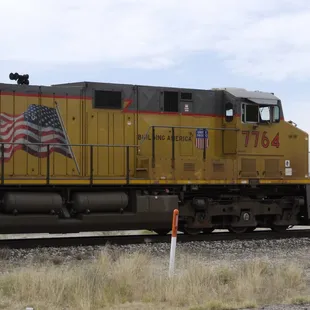 a yellow train with an american flag painted on it