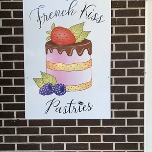 a sign on a brick wall