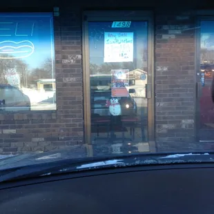 a view of a restaurant through the windshield of a car