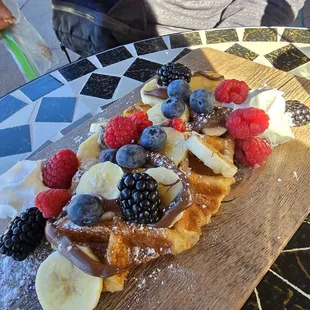 Waffle with red berries, banana, and nutella
