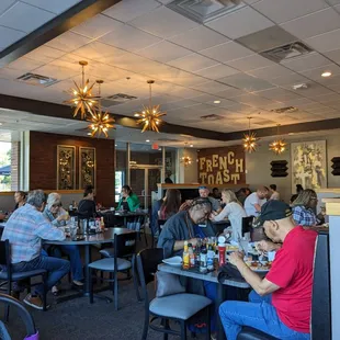 a large group of people eating in a restaurant