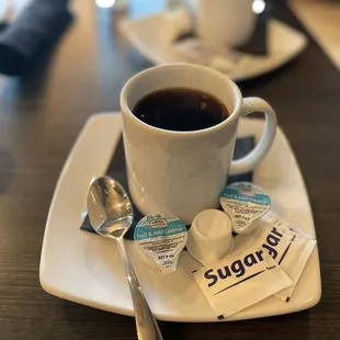 a cup of coffee and a spoon