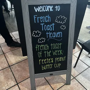 a chalkboard sign for a french toast heaven restaurant
