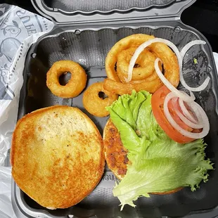 Salmon Sandwich with onion rings (seafood sauce is missing)