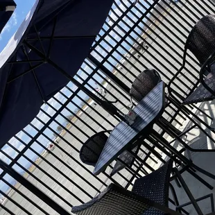 tables and chairs with umbrellas