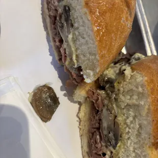 $16.50 plus tax for this hardly filled beef sandwich sat alone on a large tray with a garnish like a pickle or a chip.