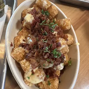 Loaded Tots with bacon and que so. YUM!! (They also come with green chili peppers. We got those on the side)