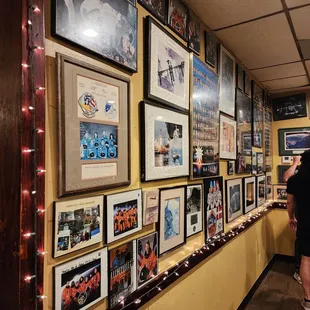 a wall of framed photos