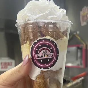 a hand holding a cup