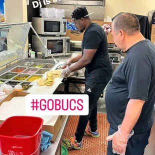 two men preparing food