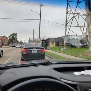 Start of the drive-thru line is out in the street on a Monday afternoon during covid.