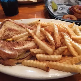 a plate of french fries and a grilled cheese sandwich