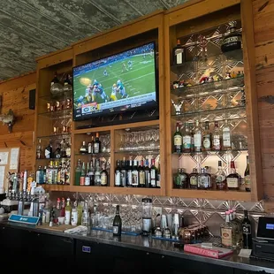 a bar with a television on the wall