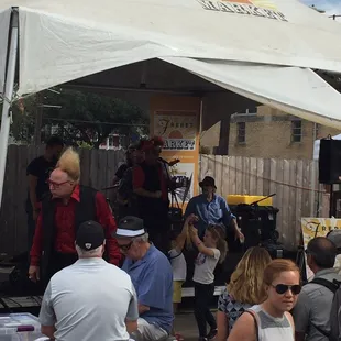 a group of people sitting under a tent