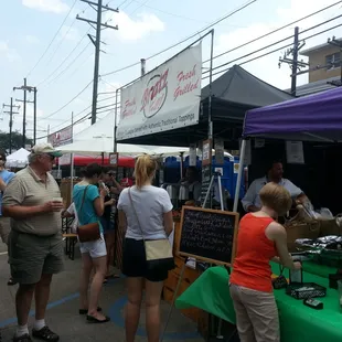 people shopping at a farmer&apos;s market