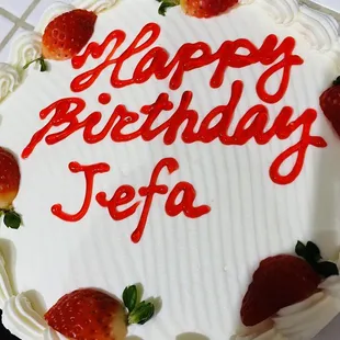 a birthday cake with strawberries