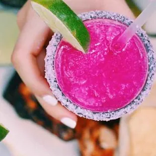 two hands holding margaritas