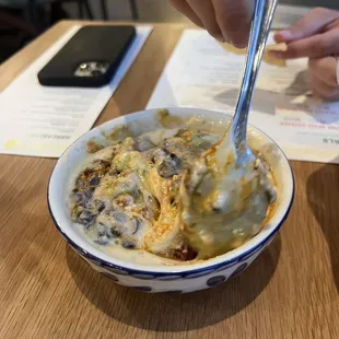 a person eating a bowl of food