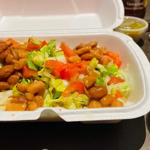 a salad in a styrofoam container