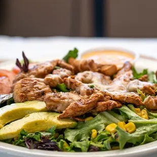a salad with chicken and avocado