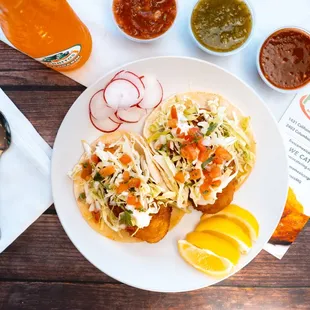 a plate of tacos and salsa