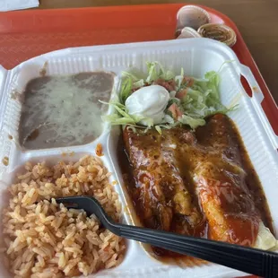 a plate of enchiladas and rice