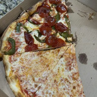 Takeout pizza. Half pepperoni and peppers, half cheese