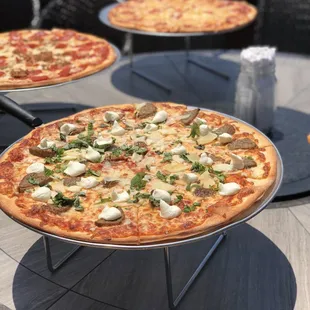 three pizzas on a table