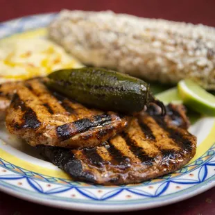 Infused Jalapeno pork chops . comes with potatoes and choice of side - delish