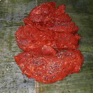 Cochinita Pibil -  (Pork marinated in Achiotte and garlic) sitting on banana leaves before wrapping (all items purchased at Fresco y Mas)