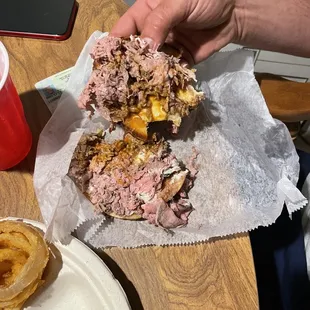 a person holding a sandwich