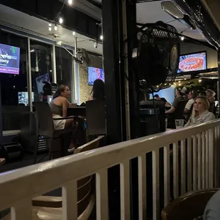 people sitting at tables in a restaurant