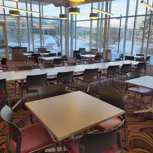 a dining area with tables and chairs