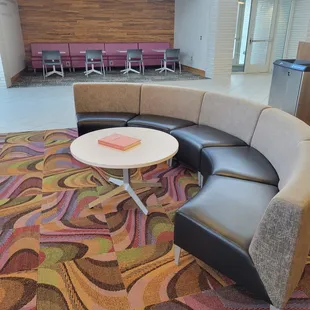a circular seating area with a coffee table
