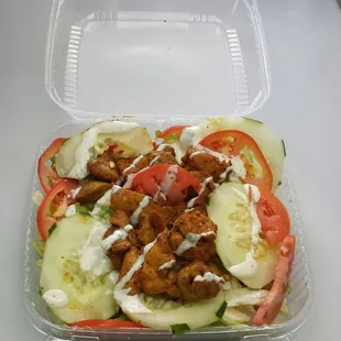 a salad in a plastic container