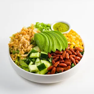 a bowl of salad with beans, avocado, corn, and beans