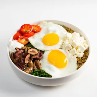 a bowl of food with eggs, meat, and vegetables