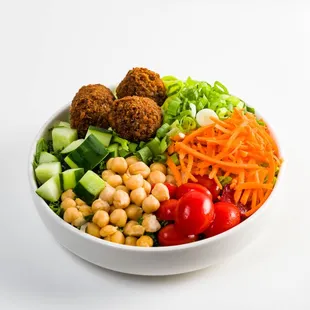 a bowl of vegetables and meatballs