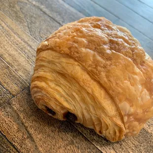 a croissant on a wooden table