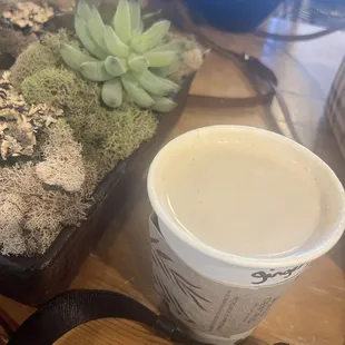 a cup of coffee and succulents