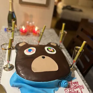 a birthday cake with a bear face on it
