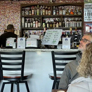 two people sitting at the bar