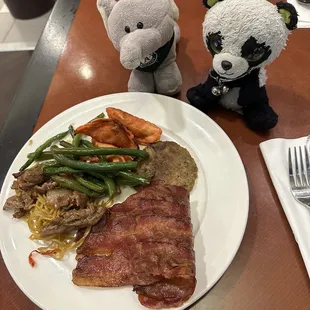 Bacon, pork sausage patty, Mongolian beef, veggie chow main, pot stickers, and stir fry green beans.