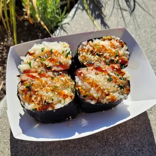 four pieces of sushi on a plate