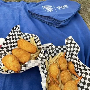 two baskets of fried fish and fries