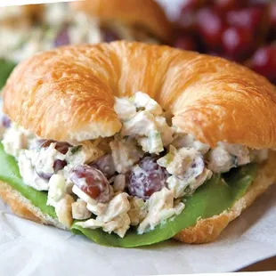 All white meat chicken salad with roasted almonds and cranberries on freshly baked croissant. We are on UBEREATS