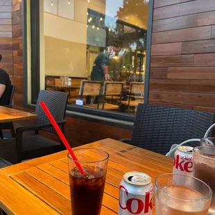 a soda and a drink on a table