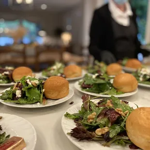 a table of sandwiches and salads