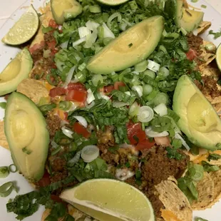 Nachos with gourmet meat sauce, topped off with fresh cilantro, green onions, peppers avocados and lime - Mexican Food Catering