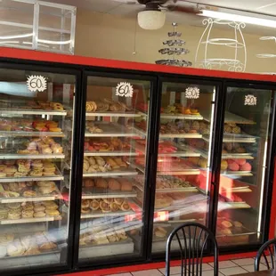 a display case of donuts in a bakery